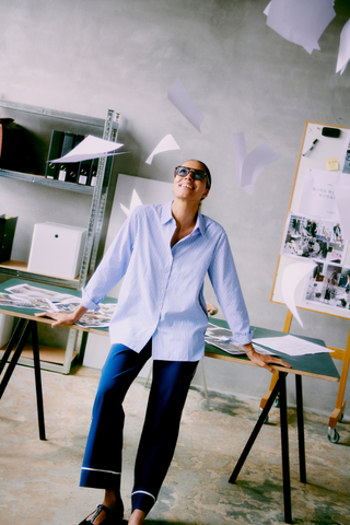 Person in a casual office setting with papers flying around b. young BYHanio Tape Shirt