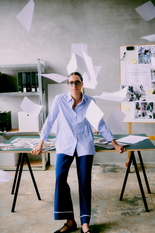 Person in a casual office setting with scattered papers b. young BYHanio Tape Shirt