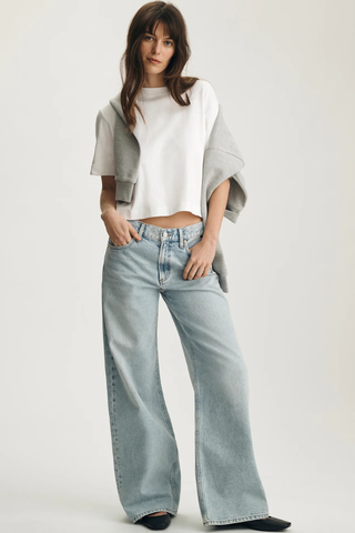 Mavi M1613686-620 Riley Crew Neck T-Shirt Woman wearing a white top and light blue jeans on a plain background