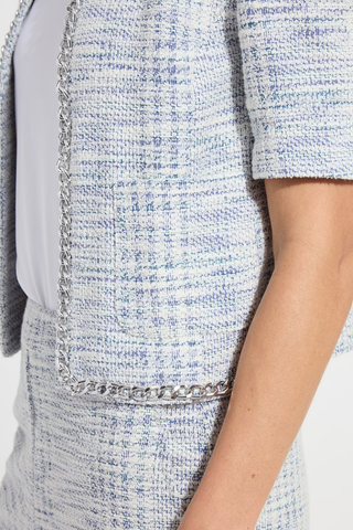 Lyssé 24-3834-M2 Lily Summer Tweed Jacket  Close-up of a textured fabric with a chain detail on a garment.