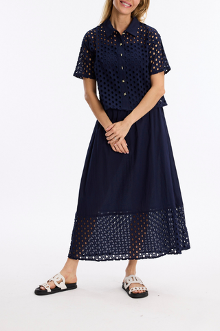 Leo & Ugo JE924 Laura Openwork Short Sleeve Blouse Woman wearing a navy dress with white polka dot pattern on a white background