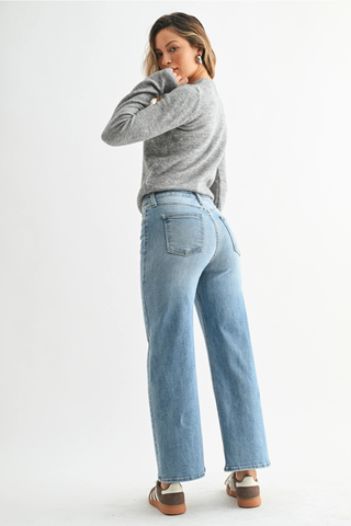 Just Black BP239J The Slim Wide LegWoman wearing a gray sweater and light blue jeans on a white background