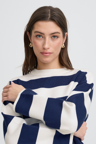 Woman wearing a navy and white striped sweater against a plain background b. young BYOtari Stripe Sweater