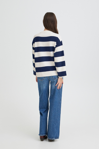 Person wearing a blue and white striped sweater and blue jeans on a white background b. young BYOtari Stripe Sweater