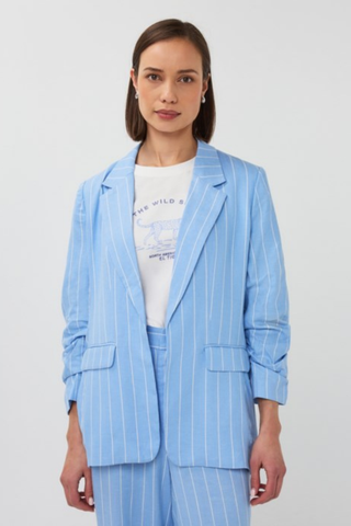 EsQualo SP2628002 Striped Linen Blazer  Woman wearing a light blue pinstripe suit with a white graphic t-shirt underneath on a plain background