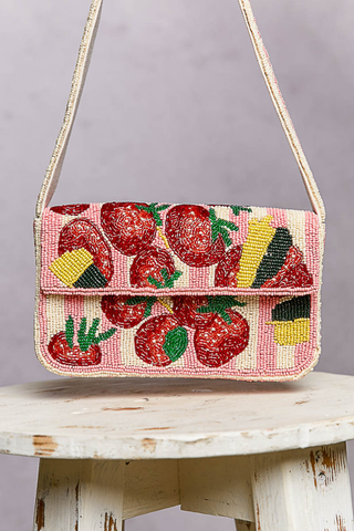 Pink Beaded Fruit Pattern Shoulder Flap Bag Beaded handbag with fruit pattern on a wooden surface