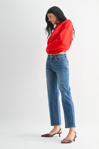 Just Black BP511J The Refined Mid Rise Slim Wide Leg  Woman wearing a red blouse and blue jeans on a white background