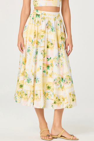 Person wearing a yellow floral skirt on a white background ASTR Kaleigh Skirt
