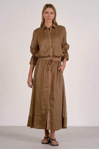 Elan RA4565 Woman wearing a brown shirt and skirt set on a white background