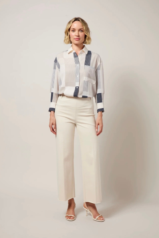 Erin Wide Leg Denim 10-3209-M9-OAT Woman wearing a patterned blouse and white pants against a plain background