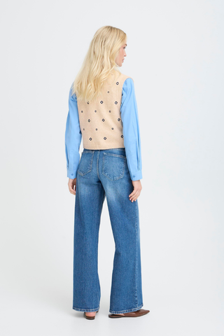 BYNadika Embroidered Vest Person wearing a blue shirt, beige vest, and blue jeans on a white background