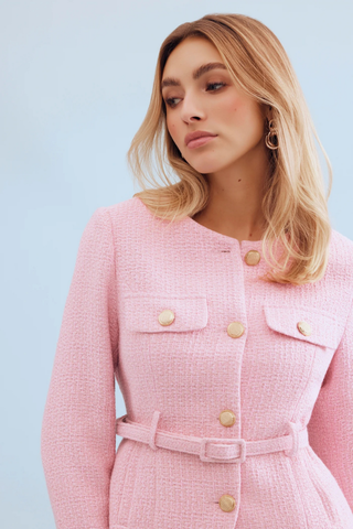 Leo & Ugo KE376 Salomé Elegant Belted Jacket - Pink Woman wearing a pink coat with gold buttons against a light blue background