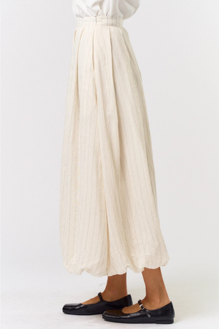 lalavon ILK4665 Ivory Pinstripe Bubble Maxi Skirt  Person wearing a white blouse and beige pleated skirt on a white background