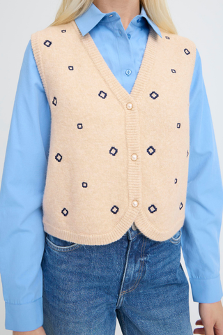 BYNadika Embroidered Vest Person wearing a beige patterned vest over a blue shirt with a white background