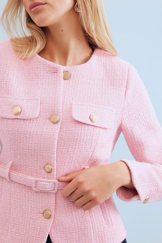 Leo & Ugo KE376 Salomé Elegant Belted Jacket - Pink Close-up of a pink textured jacket with gold buttons on a light blue background