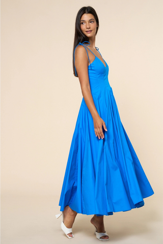 lalavon ILD6722 Fit & Flare Shoulder Tie Straps Maxi Dress  Woman wearing a blue dress against a beige background