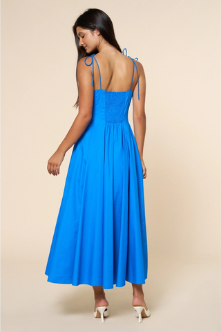 lalavon ILD6722 Fit & Flare Shoulder Tie Straps Maxi Dress  Woman wearing a blue dress against a beige background