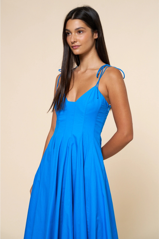 lalavon ILD6722 Fit & Flare Shoulder Tie Straps Maxi Dress  Woman wearing a blue dress against a beige background