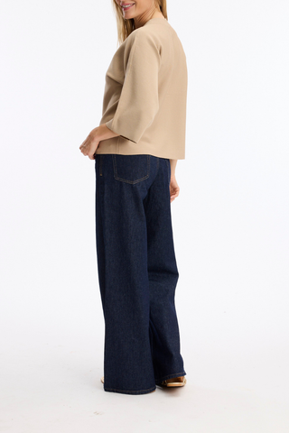 Leo & Ugo AE128 Marie Structured V-Neck Top with Wide Sleeves  Person wearing a beige top and dark blue wide-leg pants on a white background