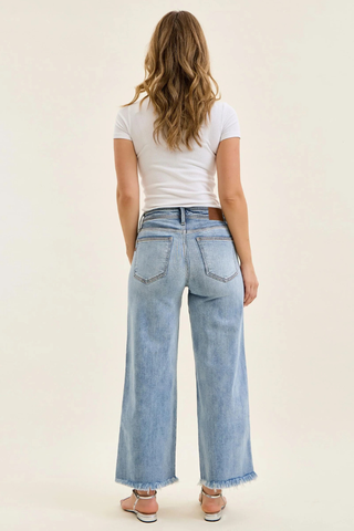 Judy Blue Mid Rise Ankle Hollywood Waistband Fray Hem Wide Leg Denim 82728REG Person wearing light blue jeans and a white t-shirt on a plain background