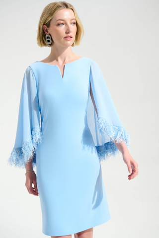 Ribkoff 261715 Signature | Silky Knit A-Line Dress With Chiffon Cape And Novelty Trim  Woman wearing a light blue dress with lace details on a white background