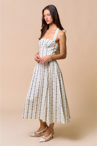 lalavon ILD6700 Bluebell Floral Halter Midi Dress Woman wearing a floral dress against a beige background