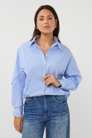 EsQualo SP2628002 Striped Batwing Blouse Woman wearing a blue striped shirt and jeans on a white background