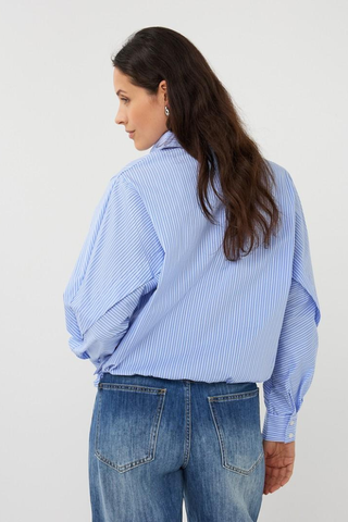 EsQualo SP2628002 Striped Batwing Blouse Woman wearing a blue striped shirt and jeans on a white background