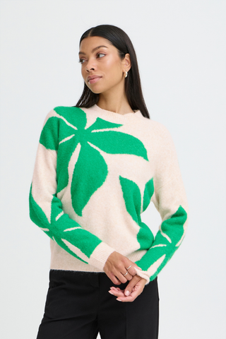 Woman wearing a green and beige patterned sweater on a white background b. young BYOmea Flower Sweater