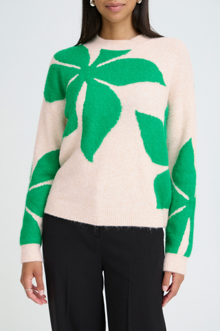 Person wearing a beige sweater with green leaf patterns on a plain background b. young BYOmea Flower Sweater