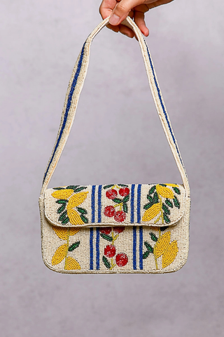 Beaded Cherry Pattern Flap Shoulder Bag POL Handbag with floral embroidery held by a hand against a gray background