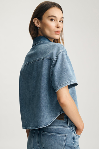 Mavi Jessie Denim Shirt M1217143 Woman wearing a blue denim jacket and jeans on a light gray background