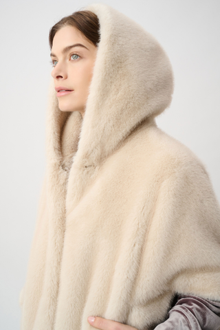 Ribkoff 264910 Short‑Sleeve Faux Fur Cocoon Coat  Woman wearing a cream-colored fur coat with a hood against a light background