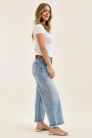 Judy Blue Mid Rise Ankle Hollywood Waistband Fray Hem Wide Leg Denim 82728REG Woman wearing light blue jeans and a white top on a plain background