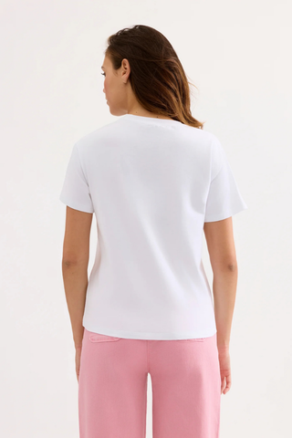 Leo & Ugo TEK074 Lennon Lemon Printed T-Shirt  Woman wearing a white t-shirt and pink pants on a light gray background