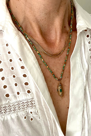 Ma Cocotte N37MAC Khiva Necklace Necklace with green beads worn by a person in a white shirt.