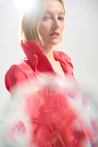 Ribkoff 261719 Signature | Stretch Taffeta Fit And Flare Dress With Lapel Collar  Woman wearing a red outfit with a blurred background