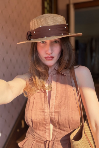  Leo & Ugo KEBH087 Pearl Detail Hat & Bag ComboWoman wearing a straw hat and brown dress, holding a bag.