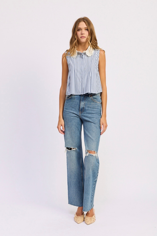 Woman wearing a striped sleeveless top and ripped jeans on a white background En Saison Clara Striped Sleeveless Top with Eyelet Collar