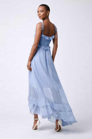 Jamie Ruffled High Low Maxi Dress WS-L25192 Woman wearing a light blue dress with thin straps on a white background