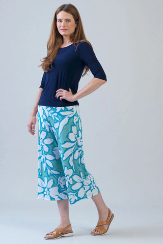 Clara Sunwoo Scoop Neck Half Sleeve Top - Navy T77 Woman wearing a navy top and blue floral pants on a gray background