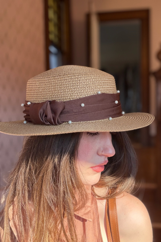 Leo & Ugo KEBH087 Pearl Detail Hat & Bag ComboWoman wearing a straw hat with a brown band and pearls indoors.