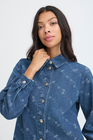 Woman wearing a blue denim shirt with a subtle pattern on a white background b. young BYKanio Shirt