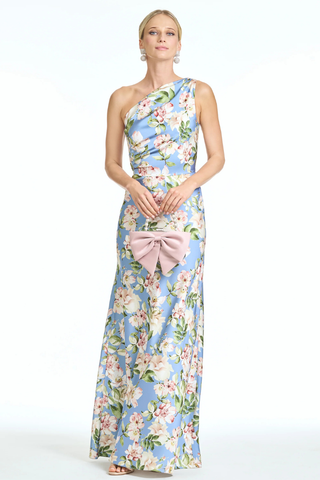 Sachin & Babi Delphine Gown - Twilight Camellias S262G32-494 Woman wearing a floral one-shoulder dress with a pink bow on a white background