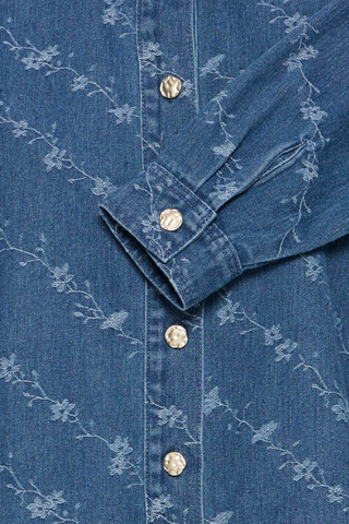 Close-up of a blue denim shirt with floral embroidery and gold buttons. b. young BYKanio Shirt