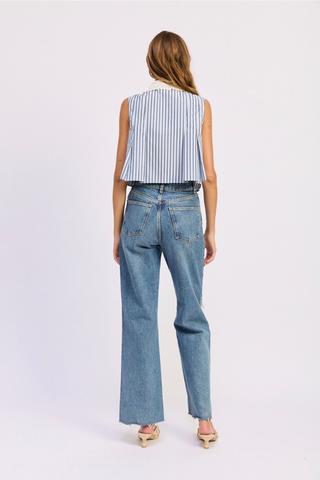 Woman wearing a striped sleeveless top and blue jeans on a white background En Saison Clara Striped Sleeveless Top with Eyelet Collar