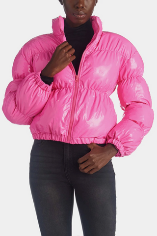 Bright hot pink cropped shiny puffer jacket with a high collar and full zip closure, displayed on a white background. The jacket has a glossy, patent-like finish.