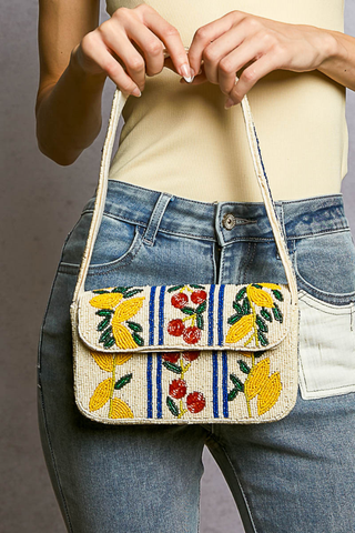 Beaded Cherry Pattern Flap Shoulder Bag POL Person holding a colorful embroidered handbag with floral patterns.