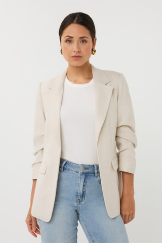 EsQualo SP2610045 Linen Look Blazer Woman wearing a beige blazer over a white shirt and blue jeans on a white background