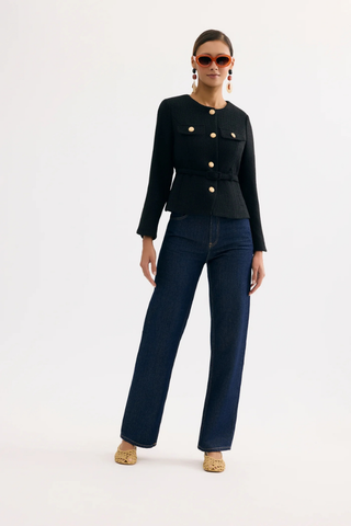 Leo & Ugo KE376 Salomé Elegant Belted Jacket - Black Woman wearing a black jacket with gold buttons and dark blue jeans on a white background